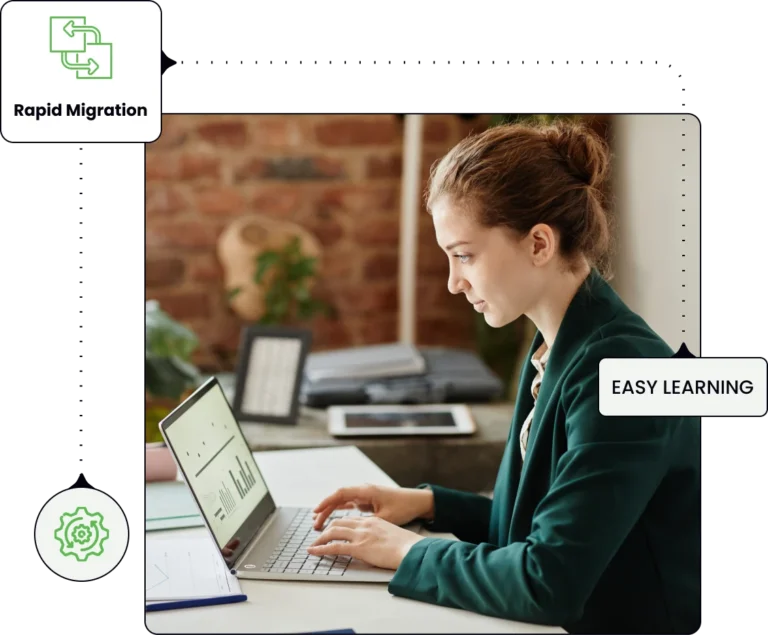 a woman sitting at a desk and working on a laptop