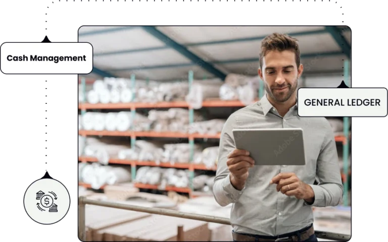 a manstanding in a warehouse and looking at his tablet