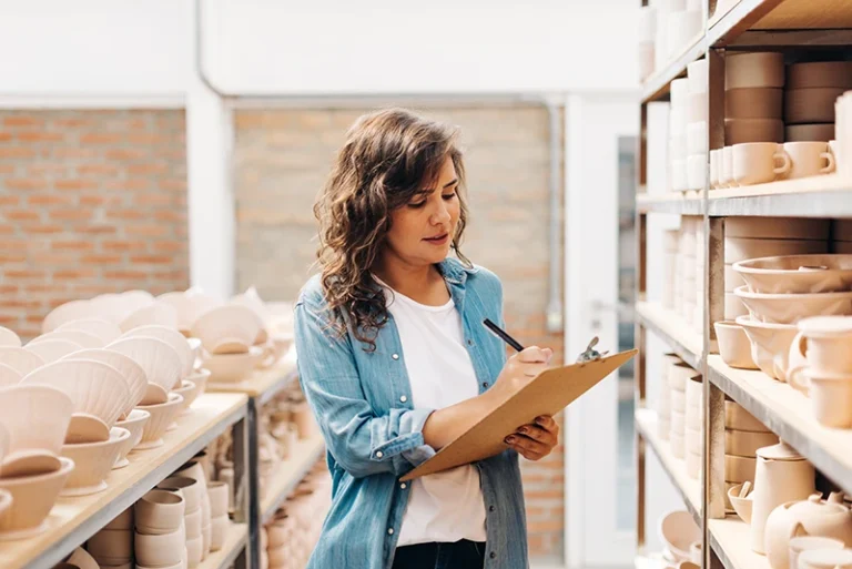 woman taking notes at a warehouse