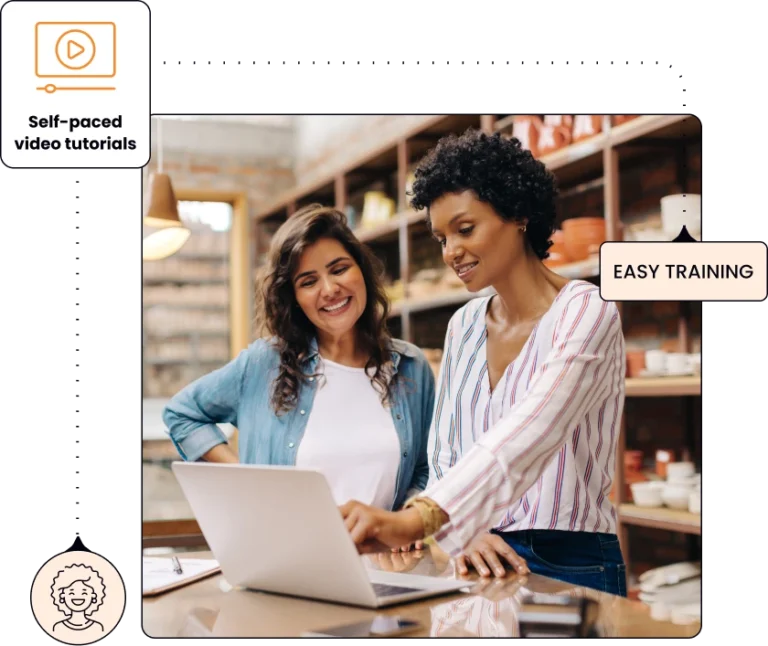 two women looking at a laptop and discussing something