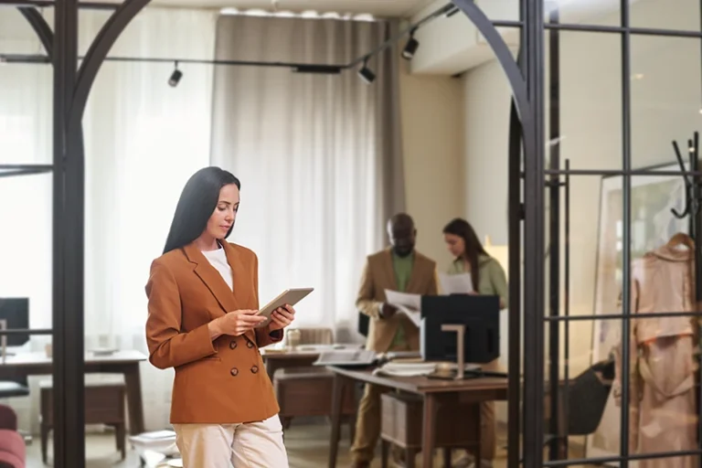 Two women and a man working in an office