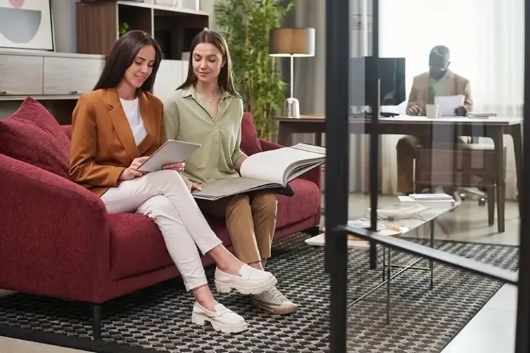 Two women and a man working in an office