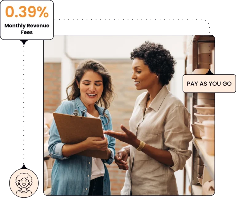 two woman having a conversation and looking at a clipboard